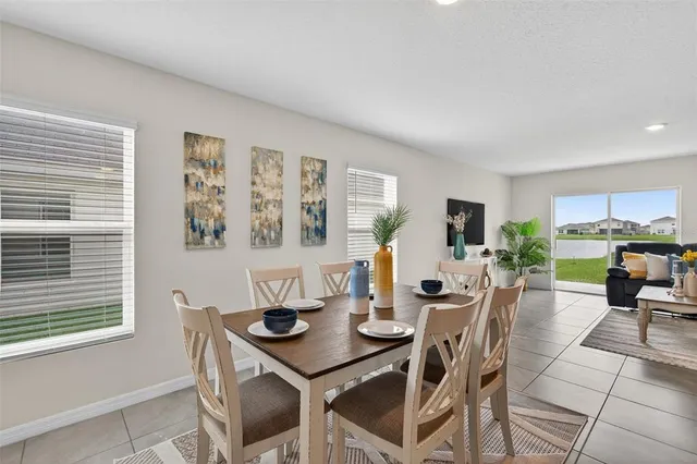 a living room with furniture and kitchen view