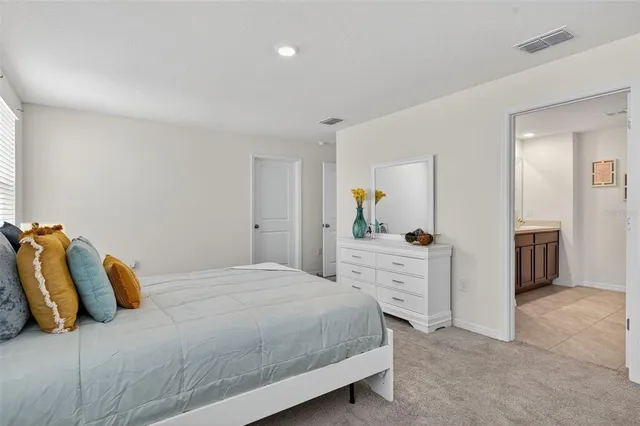 a bathroom with a granite countertop sink a toilet and shower