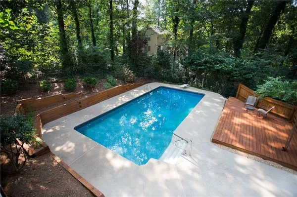 a view of a swimming pool with a yard