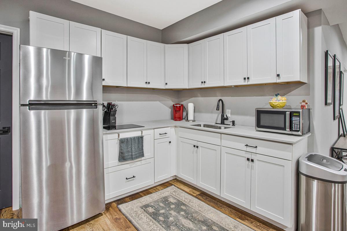 5 Jessie Road Harwood, MD 20776 - Photo 63 of 87 a kitchen with a refrigerator sink and cabinets
