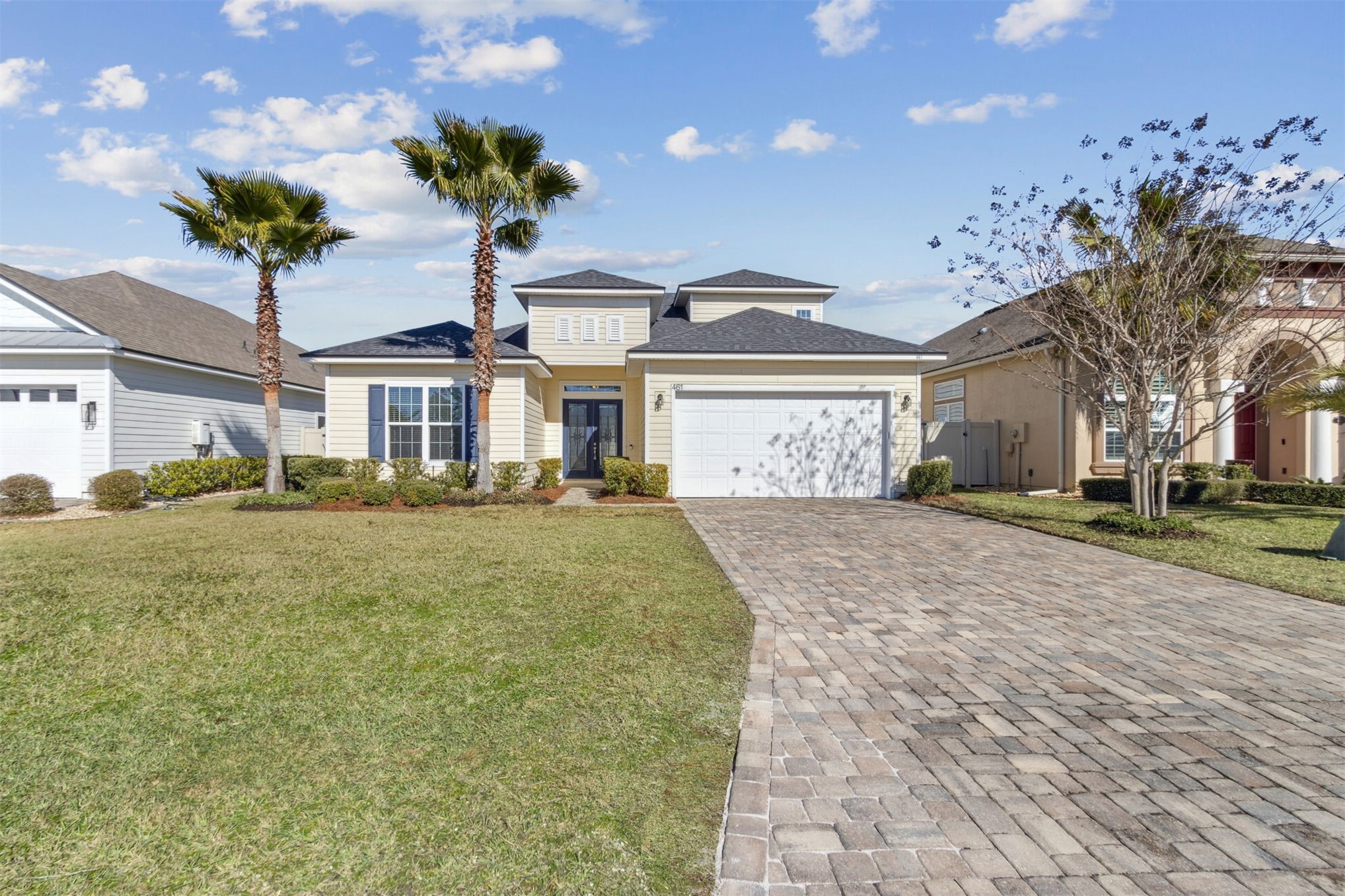 461 Sargasso Street Fernandina Beach, FL 32034 - Photo 12 of 40 a front view of a house with a yard and a garden