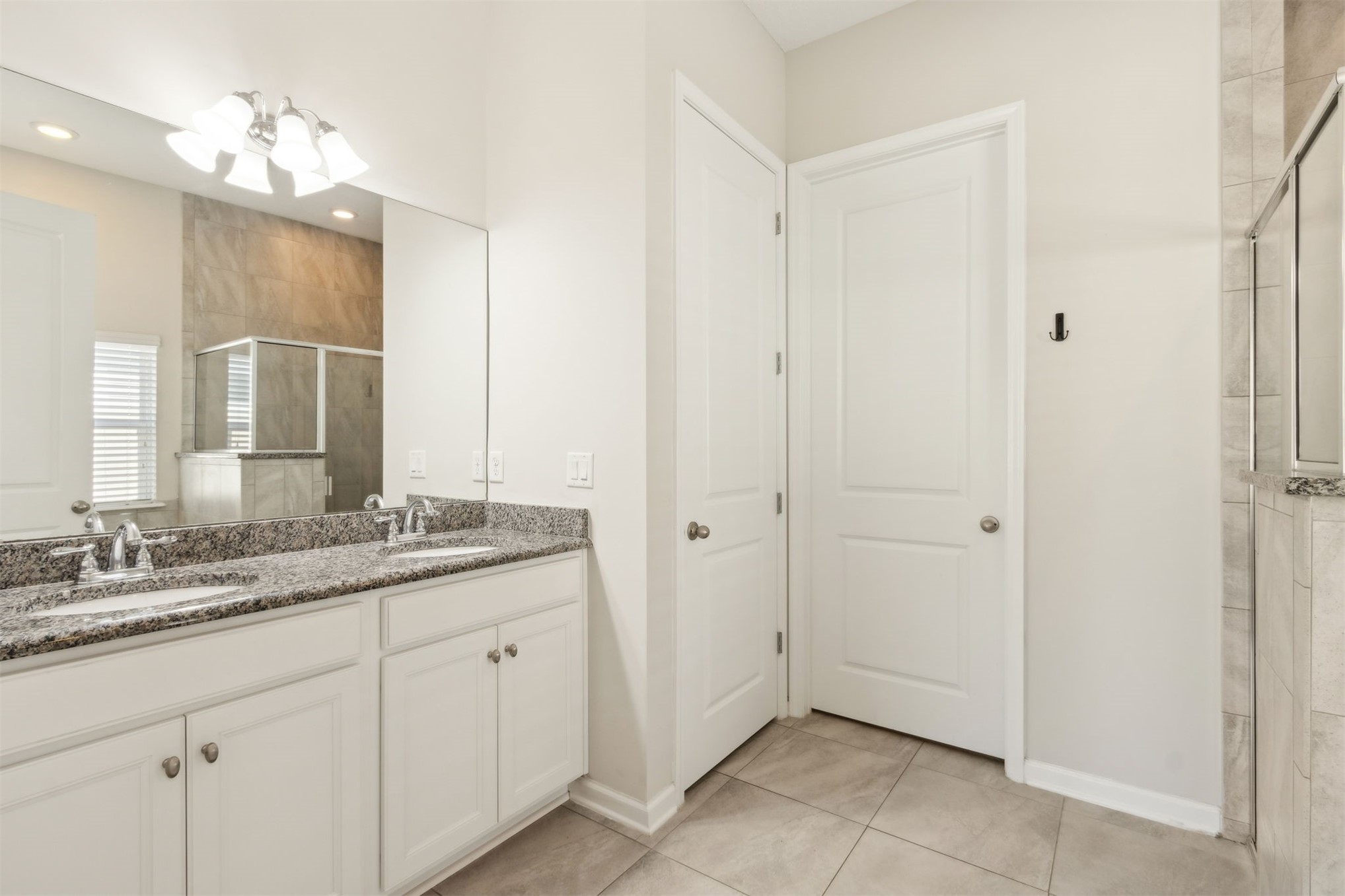 461 Sargasso Street Fernandina Beach, FL 32034 - Photo 25 of 40 a bathroom with a granite countertop sink two mirror and a