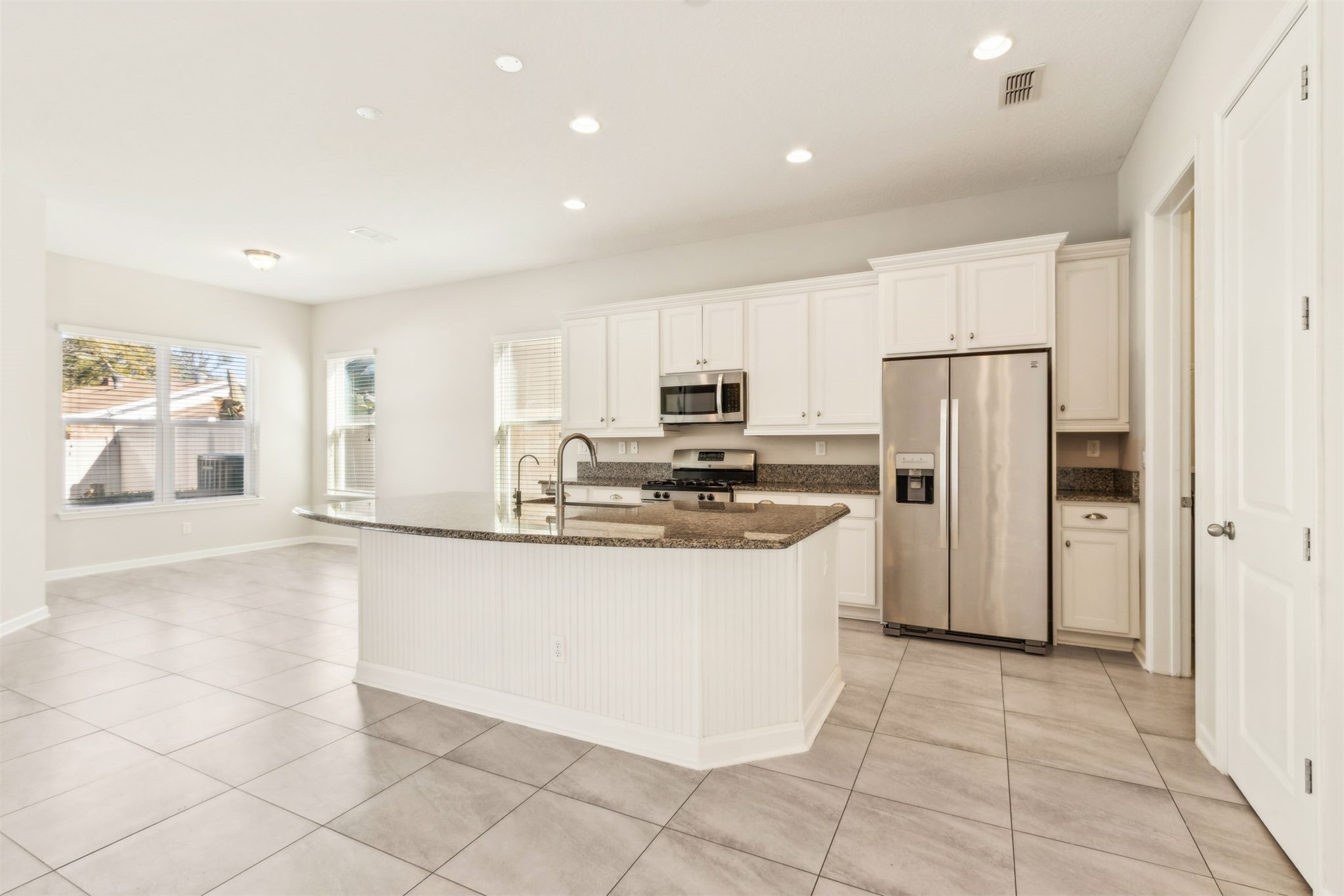 461 Sargasso Street Fernandina Beach, FL 32034 - Photo 40 of 40 a large kitchen with stainless steel appliances granite countertop a refrigerator and a stove top oven