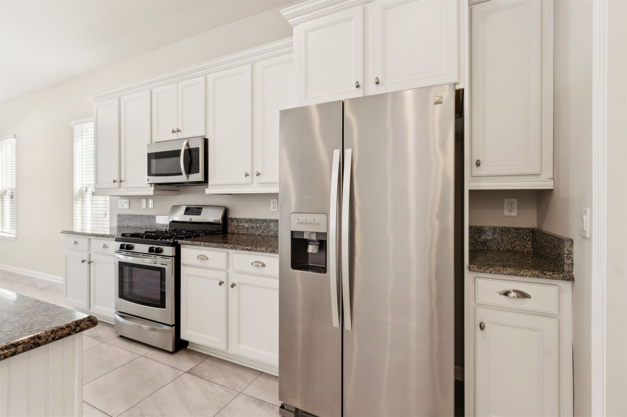 461 Sargasso Street Fernandina Beach, FL 32034 - Photo 8 of 40 a kitchen with stainless steel appliances granite countertop a refrigerator sink and white cabinets