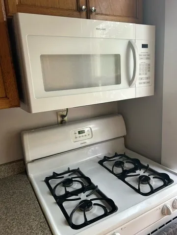 a stove top oven sitting inside of a kitchen