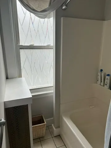 a bathroom with a bathtub and a shower