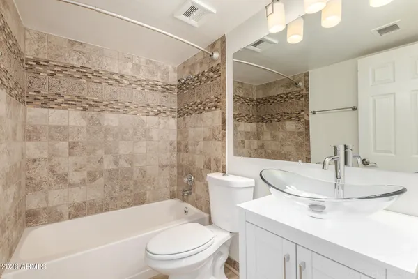 a bathroom with a sink a toilet and a bathtub