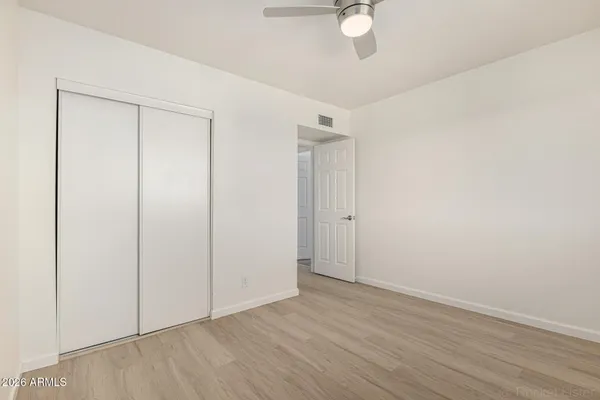 a view of an empty room with wooden floor