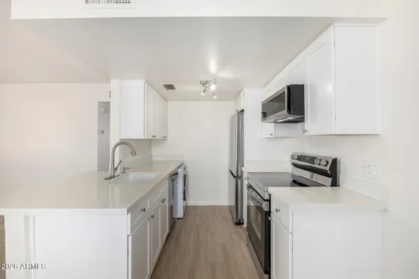 a kitchen that has a sink and a stove in it