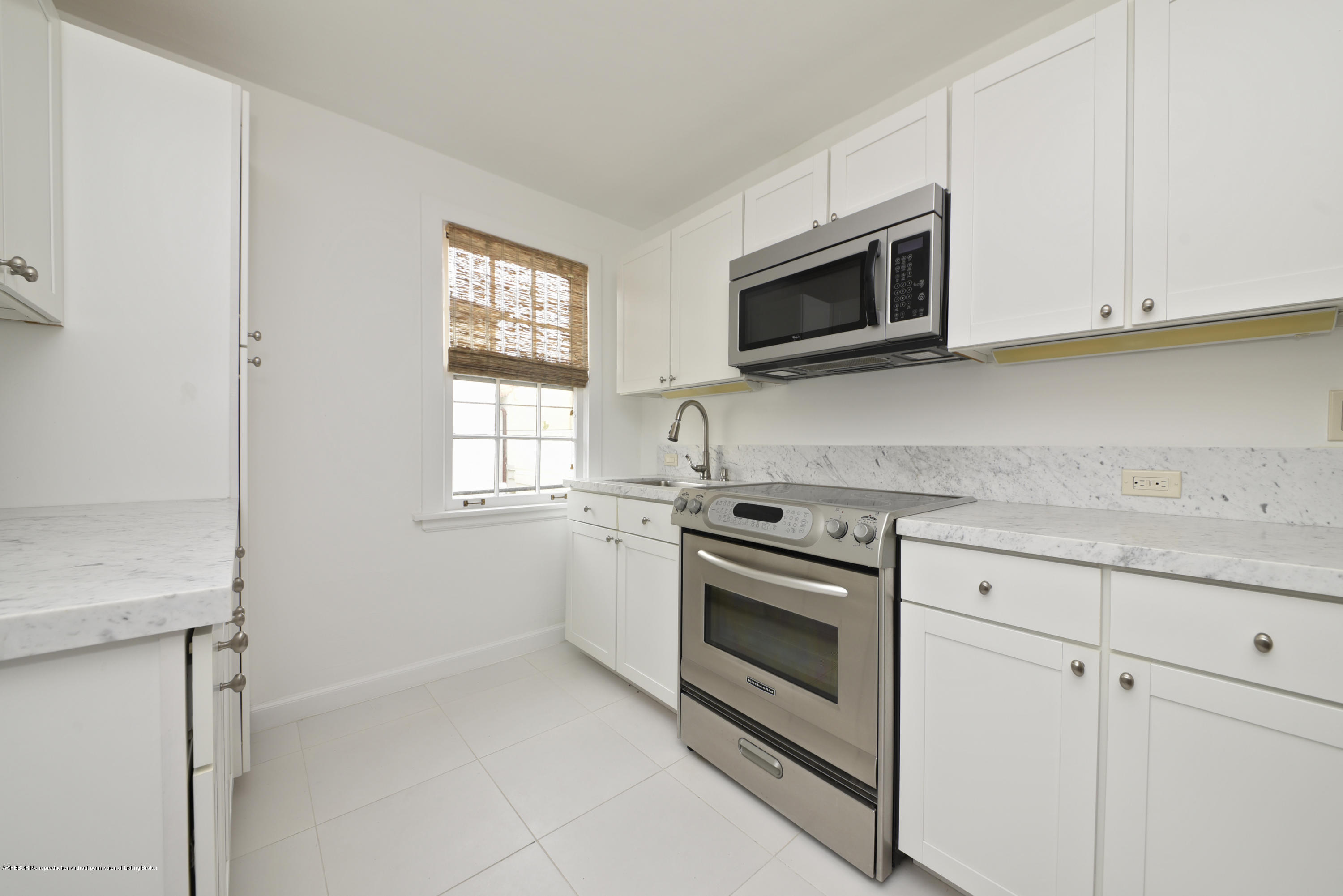 9 Golfview Road Palm Beach, FL 33480 - Photo 29 of 57 a kitchen with stainless steel appliances white cabinets and a stove top oven