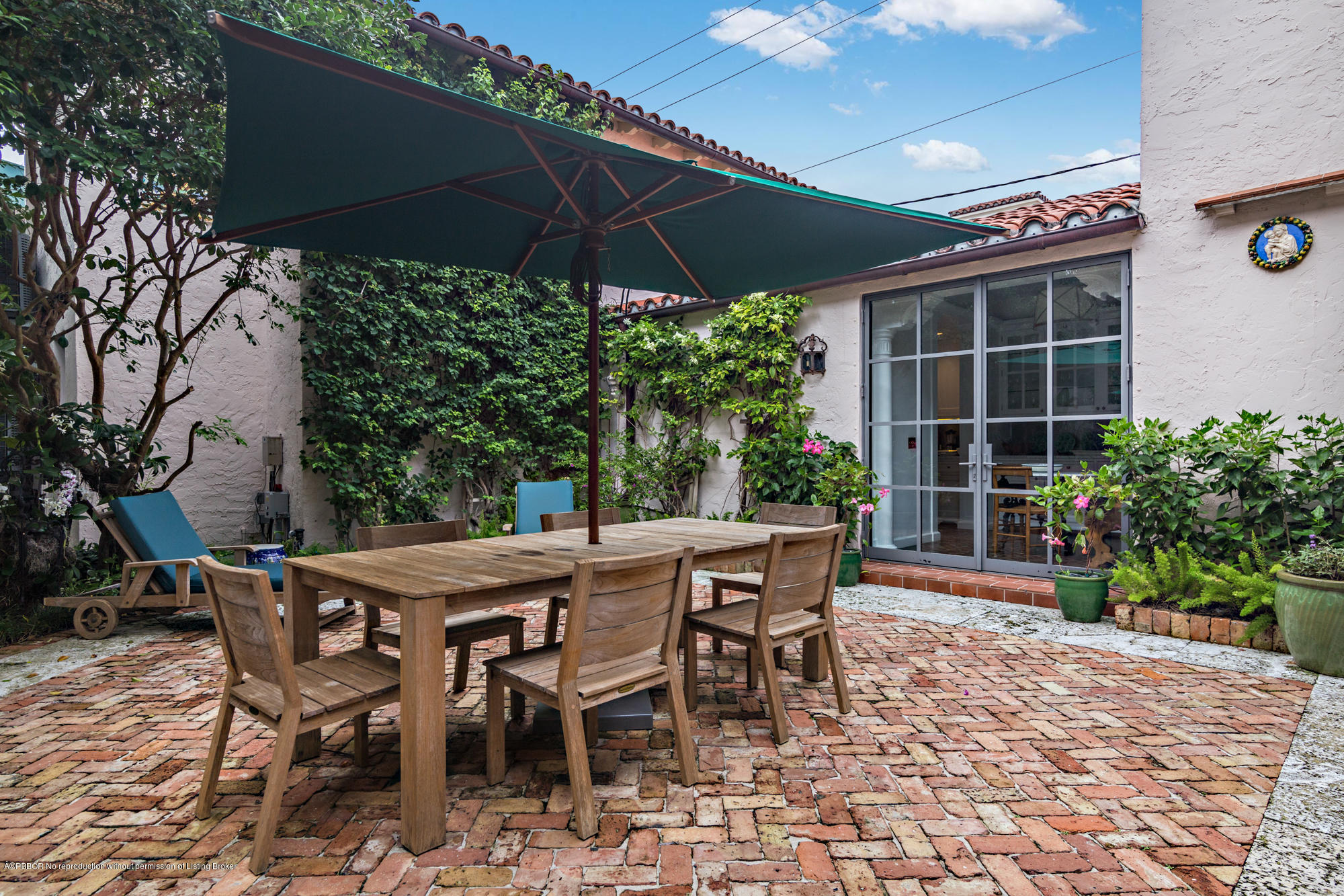 9 Golfview Road Palm Beach, FL 33480 - Photo 49 of 57 a view of a table and chairs under an umbrella