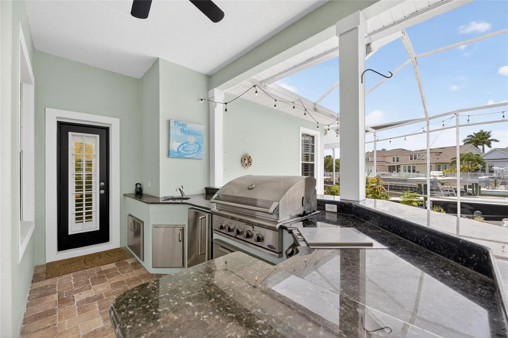 508 Islebay Drive Apollo Beach, FL 33572 - Photo 82 of 98 a kitchen with stainless steel appliances granite countertop a stove and a sink with granite countertops