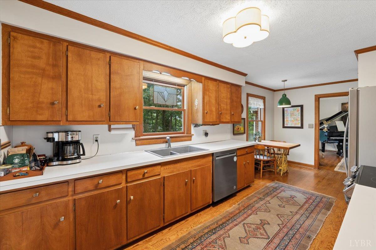 3289 Peaks Road Bedford, VA 24523 - Photo 14 of 71 a view of a kitchen counter top space with stainless steel appliances granite countertop furniture a sink and a large window