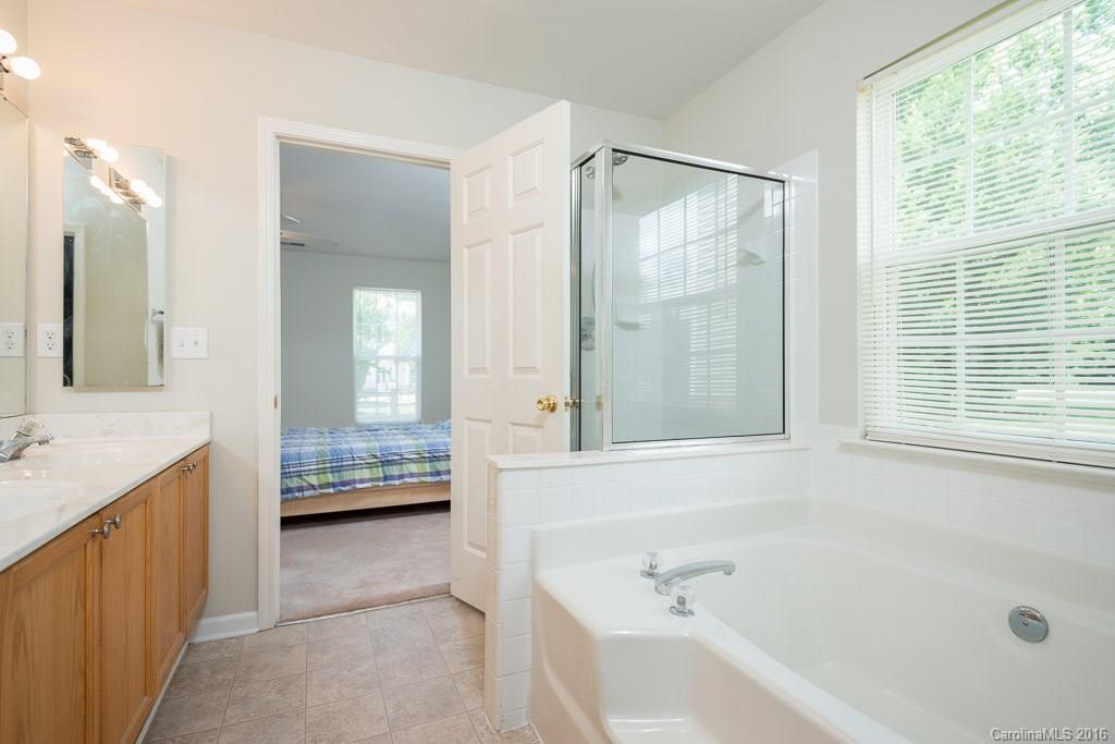 624 Eaton Court Fort Mill, SC 29708 - Photo 11 of 24 a bathroom with a tub sink and mirror