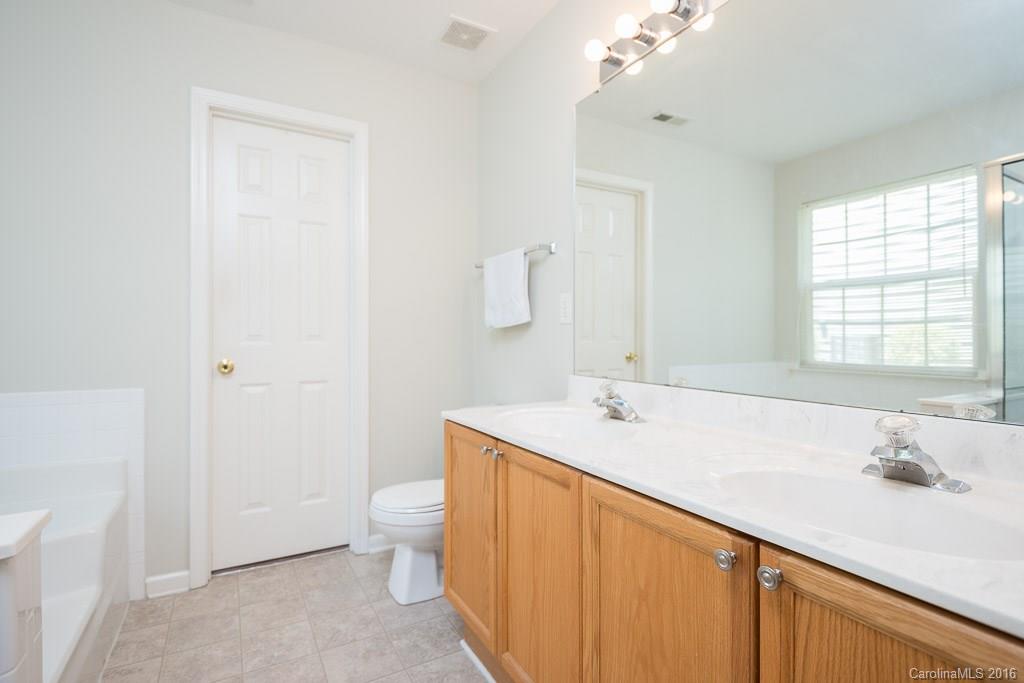 624 Eaton Court Fort Mill, SC 29708 - Photo 12 of 24 a bathroom with a sink a toilet and shower