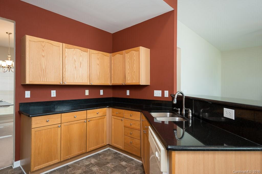 624 Eaton Court Fort Mill, SC 29708 - Photo 3 of 24 a kitchen with granite countertop a sink and white cabinets