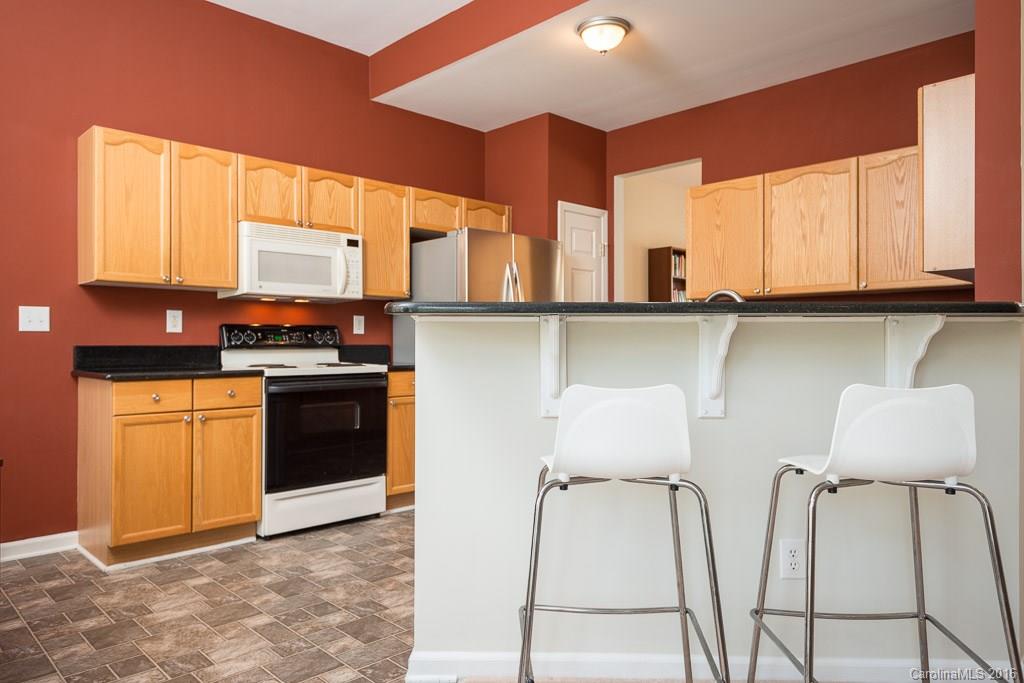624 Eaton Court Fort Mill, SC 29708 - Photo 4 of 24 a kitchen with stainless steel appliances granite countertop a stove a sink and a microwave