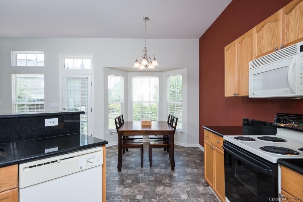 624 Eaton Court Fort Mill, SC 29708 - Photo 5 of 24 a kitchen with a stove and a chandelier