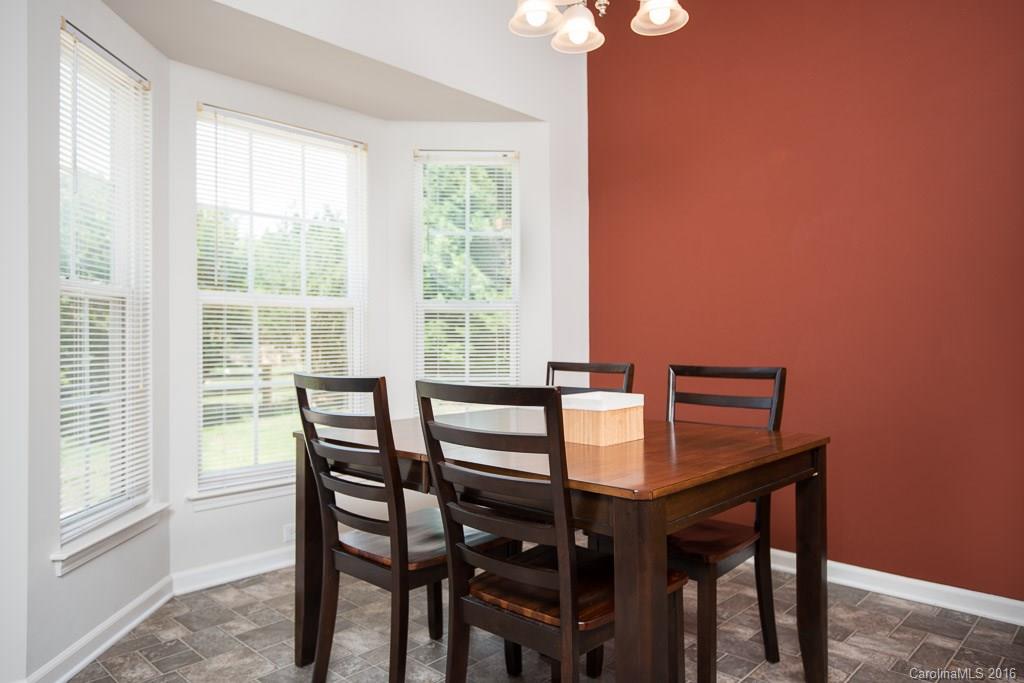 624 Eaton Court Fort Mill, SC 29708 - Photo 6 of 24 a view of a dining room with furniture and a chandelier