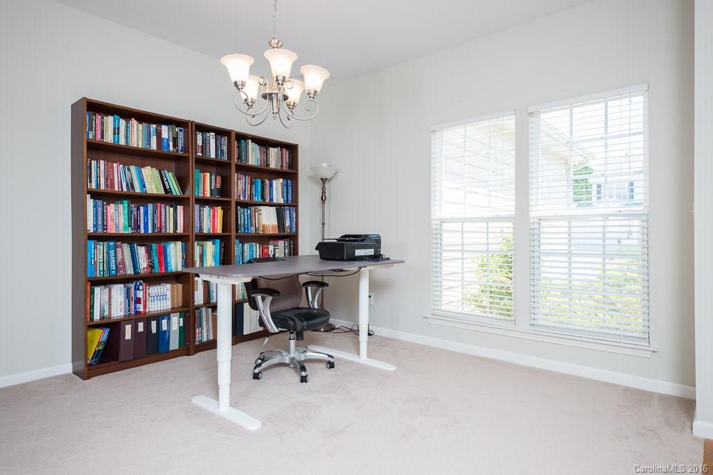 624 Eaton Court Fort Mill, SC 29708 - Photo 7 of 24 a view of a workspace with a bookshelf and a window