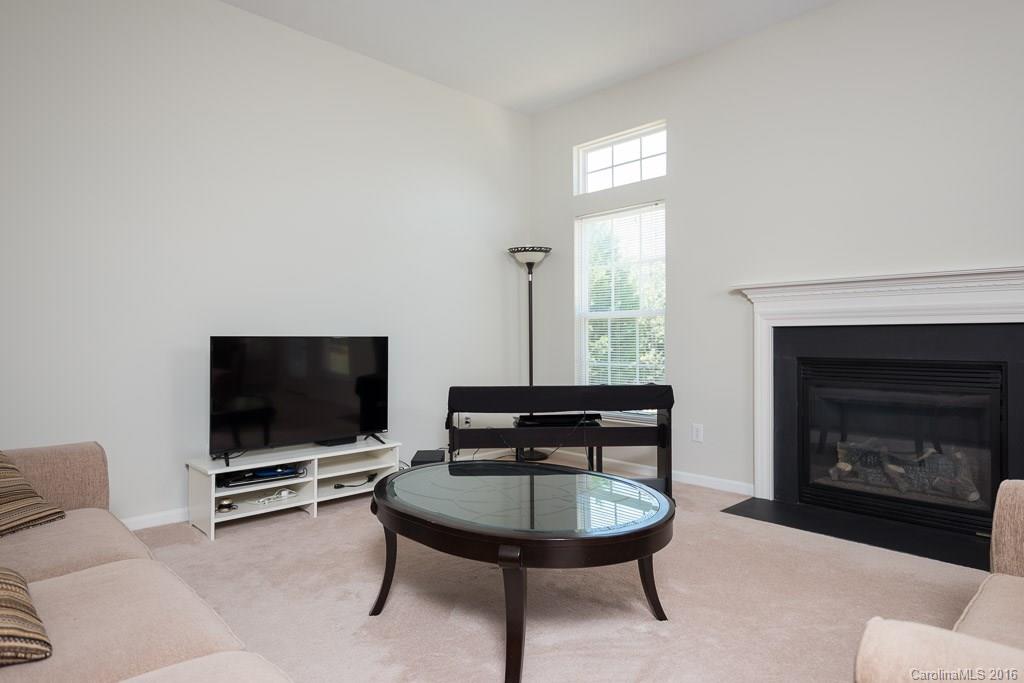 624 Eaton Court Fort Mill, SC 29708 - Photo 8 of 24 a living room with furniture a flat screen tv and a fireplace