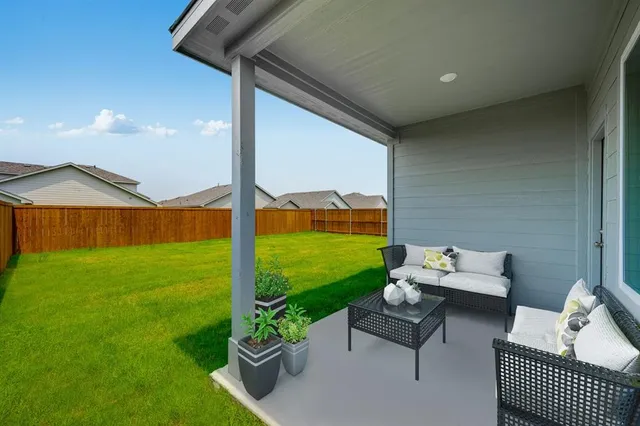 a balcony with furniture and garden view