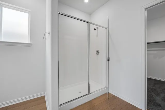 a bathroom with a glass shower door