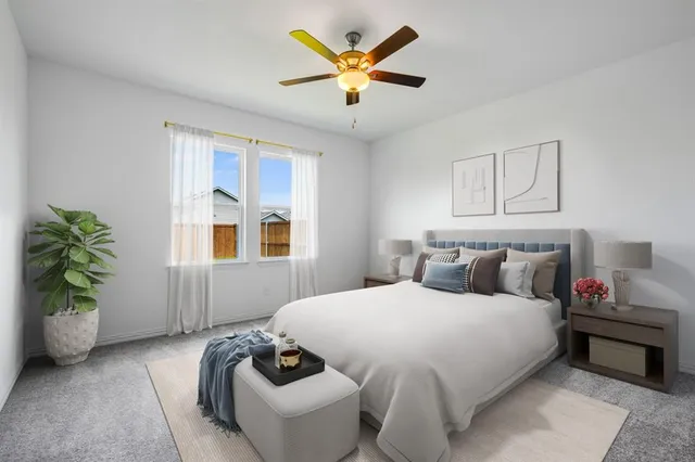 a bedroom with a bed and ceiling fan