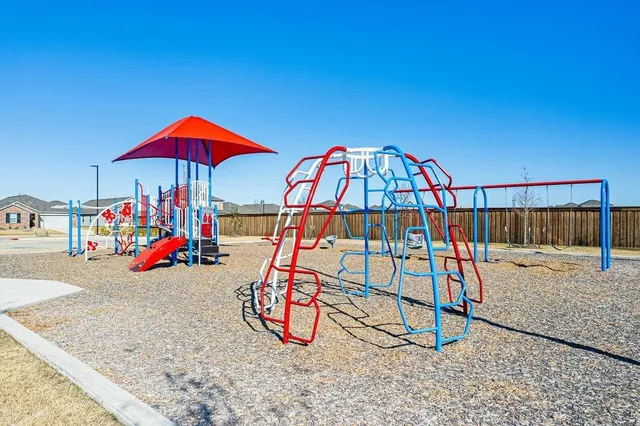 a view of a garden with large trees