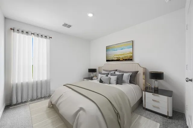 a bedroom with bed and a window