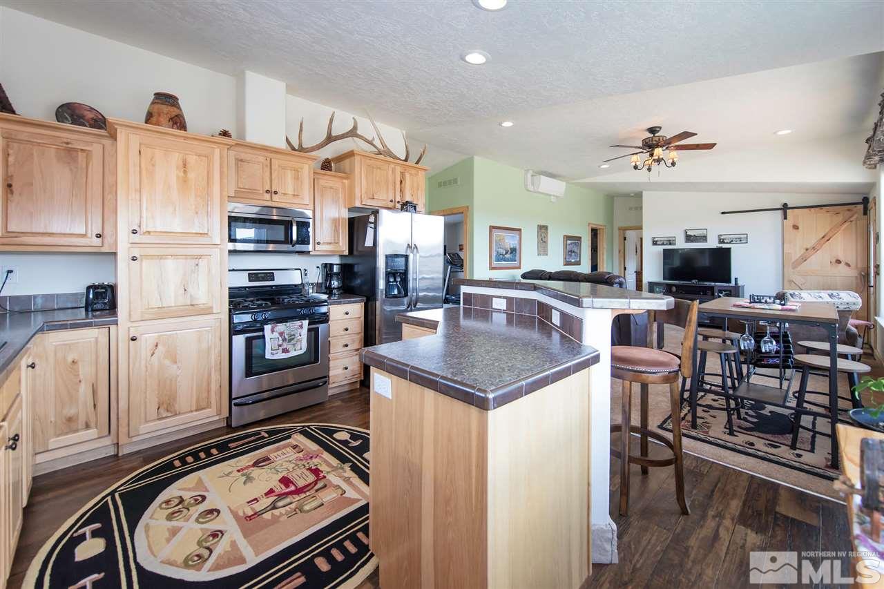 3230 Cartwright Road Reno, NV 89521 - Photo 16 of 25 a kitchen with stainless steel appliances granite countertop a sink stove and cabinets