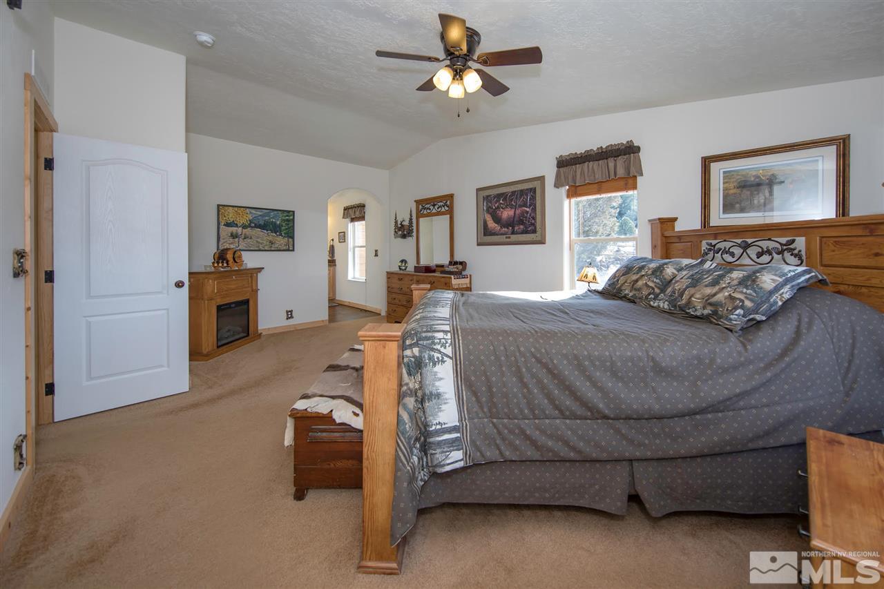 3230 Cartwright Road Reno, NV 89521 - Photo 17 of 25 a bedroom with a bed and a chandelier