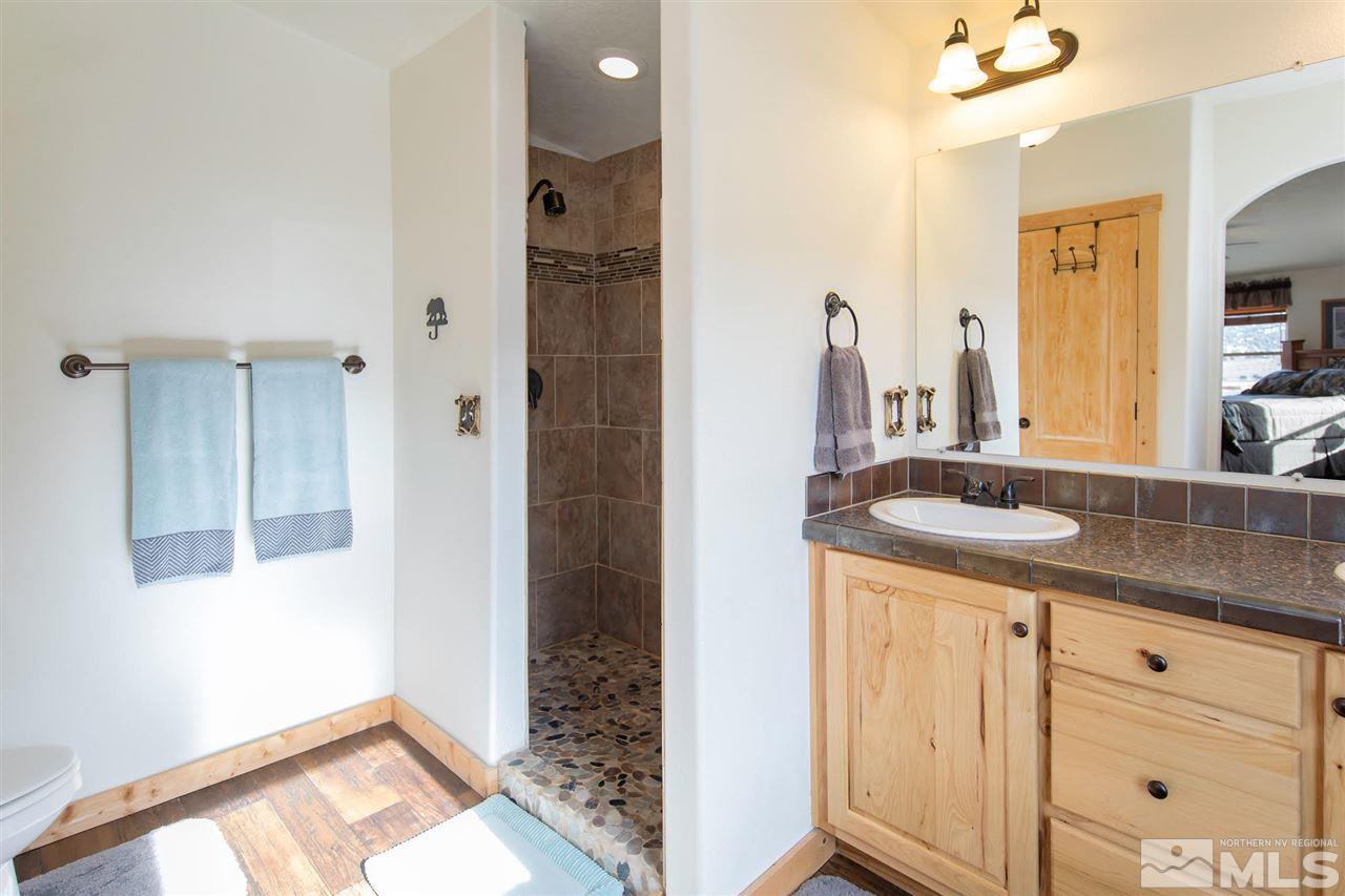 3230 Cartwright Road Reno, NV 89521 - Photo 20 of 25 a bathroom with a granite countertop sink and a mirror