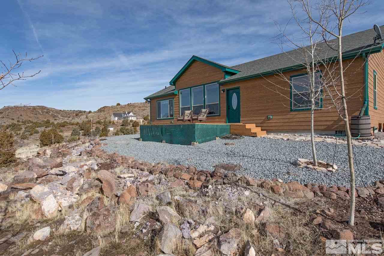 3230 Cartwright Road Reno, NV 89521 - Photo 4 of 25 a front view of a house with a yard and garage