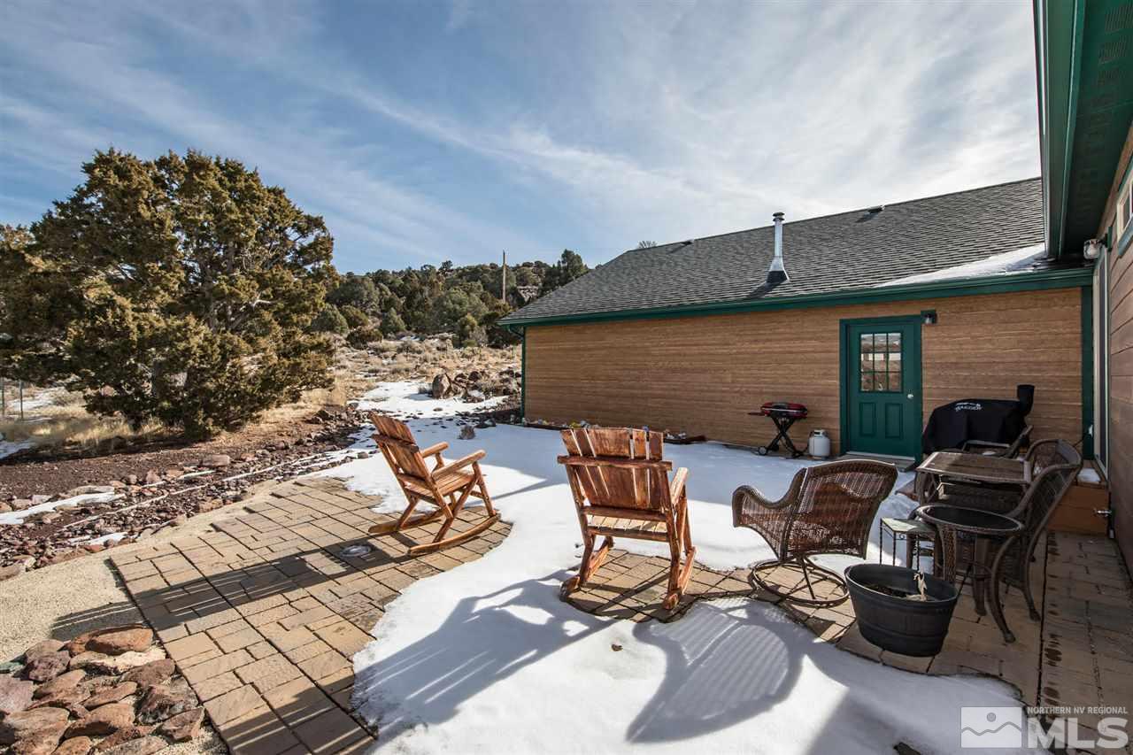 3230 Cartwright Road Reno, NV 89521 - Photo 7 of 25 a view of a patio with table and chairs and potted plants