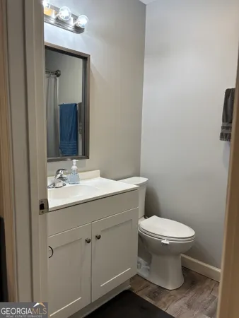 a bathroom with a toilet sink and mirror