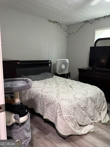 a bedroom with a bed and a television