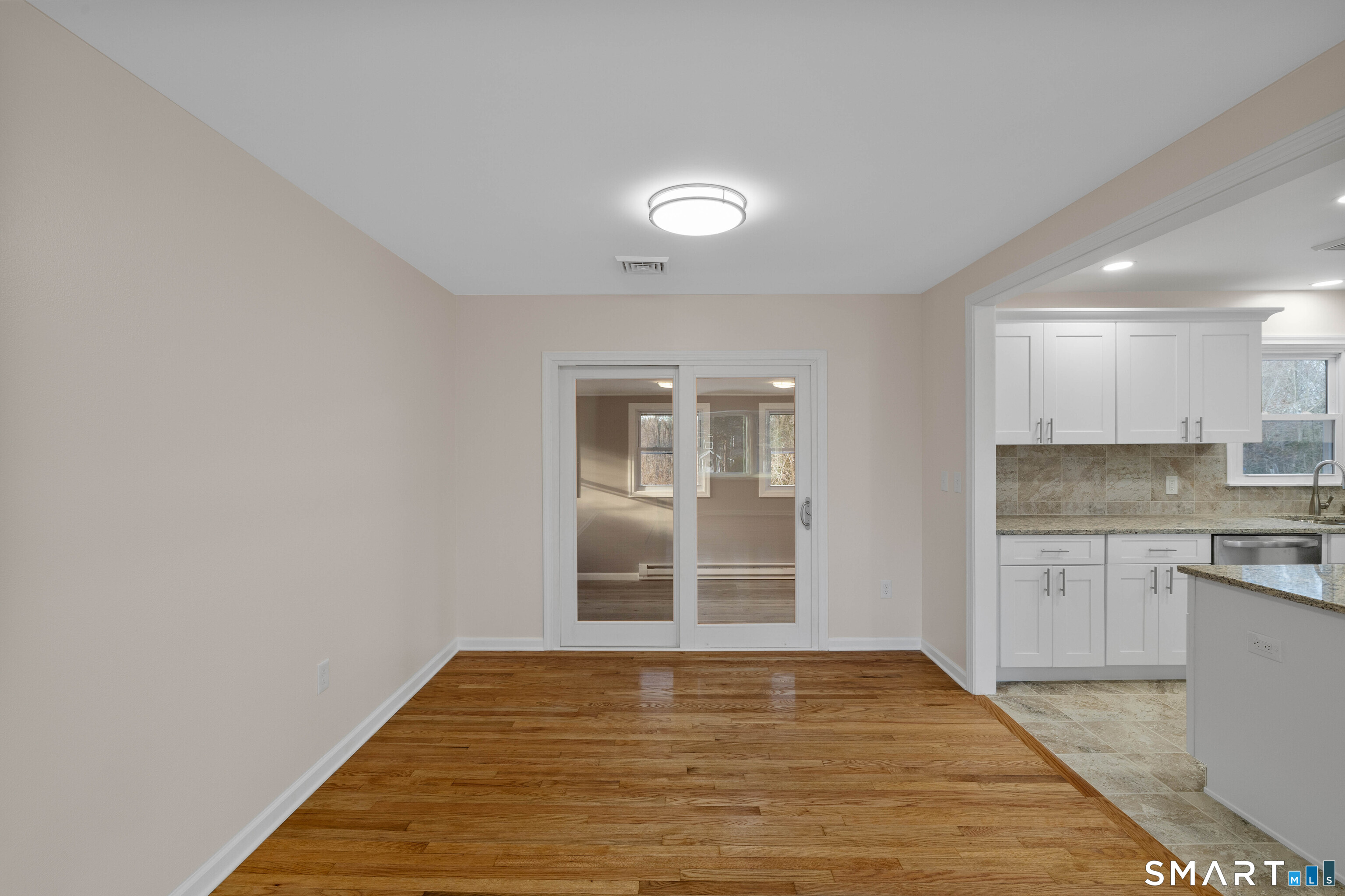 31 Branch Hill Road Preston, CT 06365 - Photo 14 of 40 a view of a kitchen with a sink and dishwasher with wooden floor