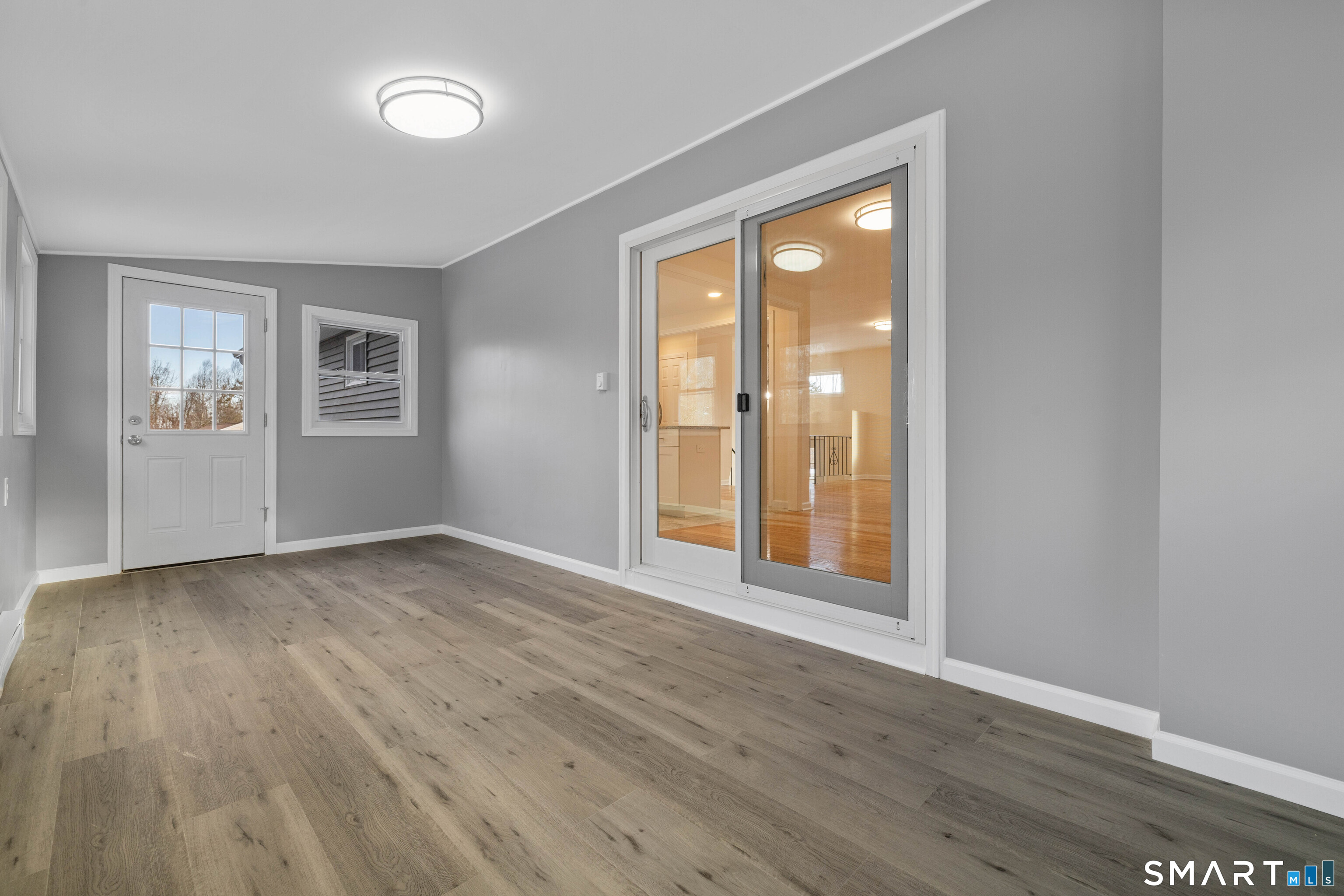 31 Branch Hill Road Preston, CT 06365 - Photo 20 of 40 an empty room with wooden floor and windows