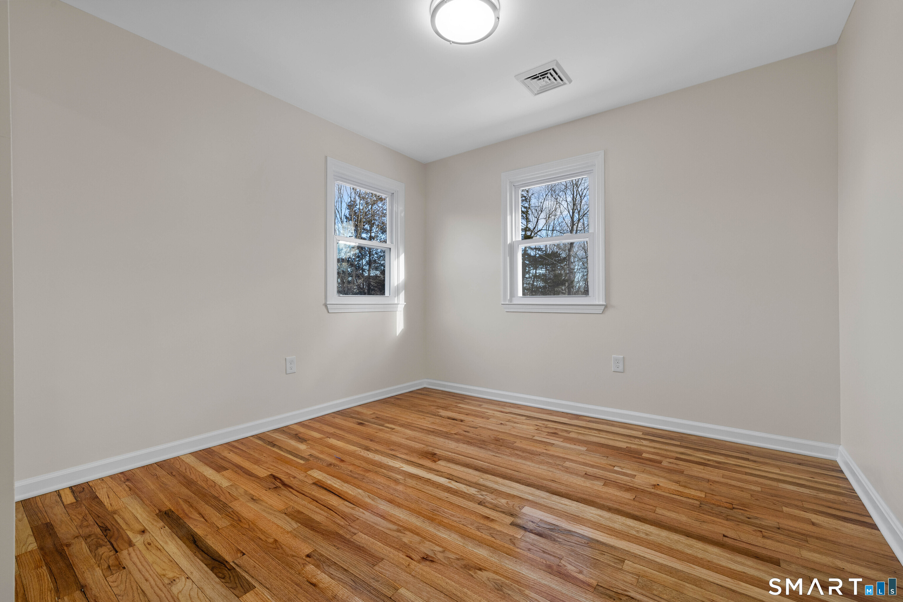 31 Branch Hill Road Preston, CT 06365 - Photo 25 of 40 an empty room with wooden floor and windows