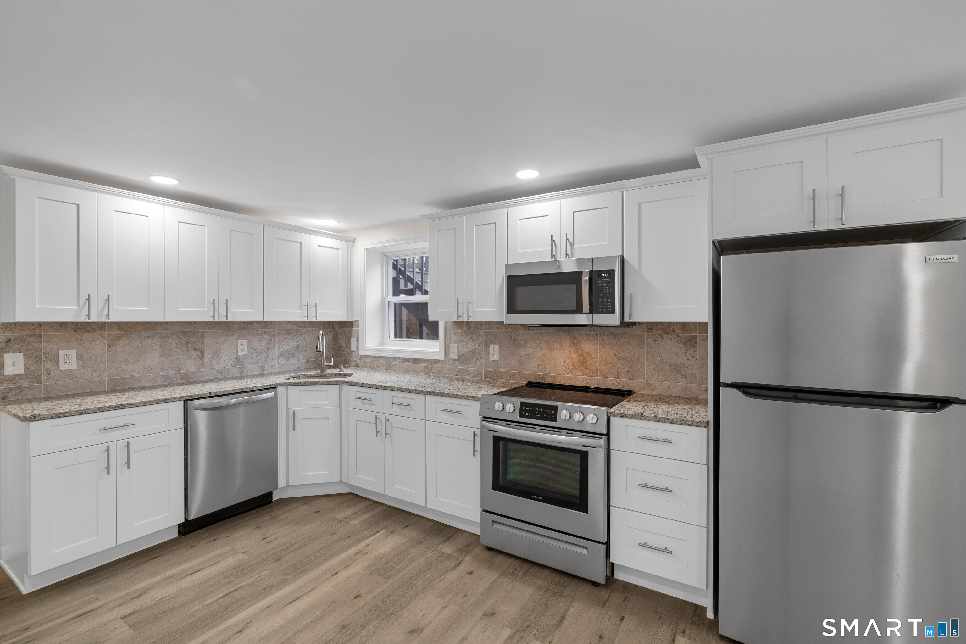 31 Branch Hill Road Preston, CT 06365 - Photo 31 of 40 a kitchen with stainless steel appliances granite countertop a stove a refrigerator and a microwave
