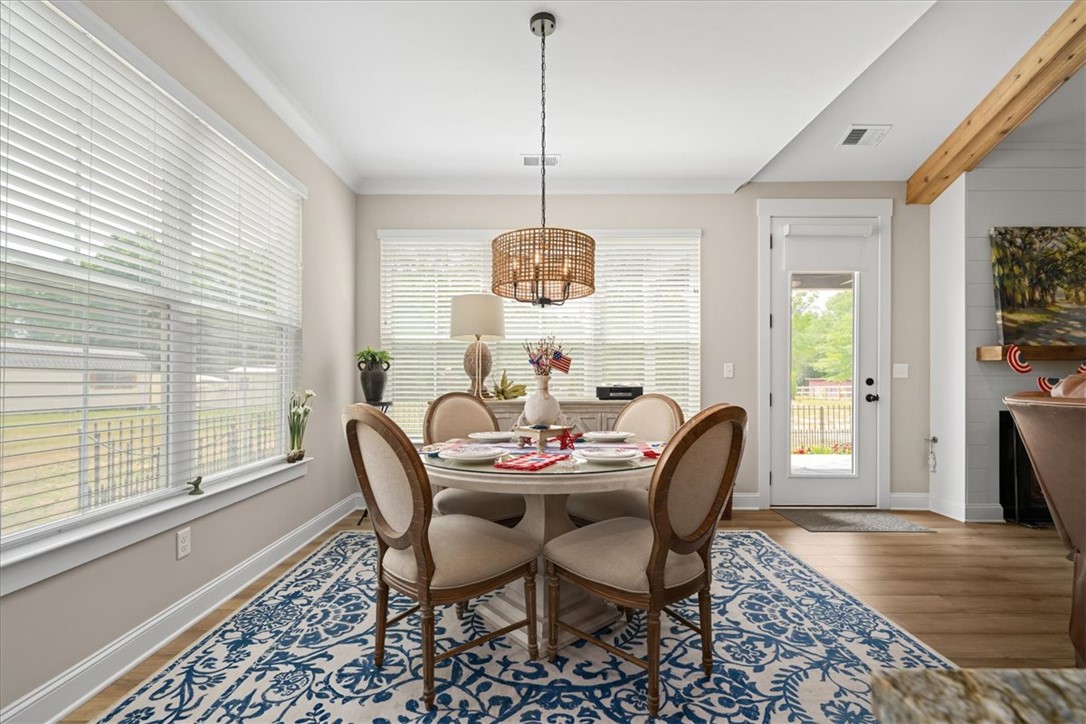 6834 Midway Road Pelzer, SC 29669 - Photo 18 of 50 This dining area features abundant natural light and seamless outdoor access.
