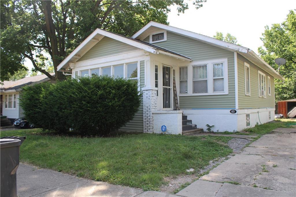 a front view of a house with a garden and plants