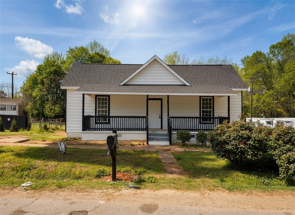 This charming home offers a welcoming facade with a cozy front porch.