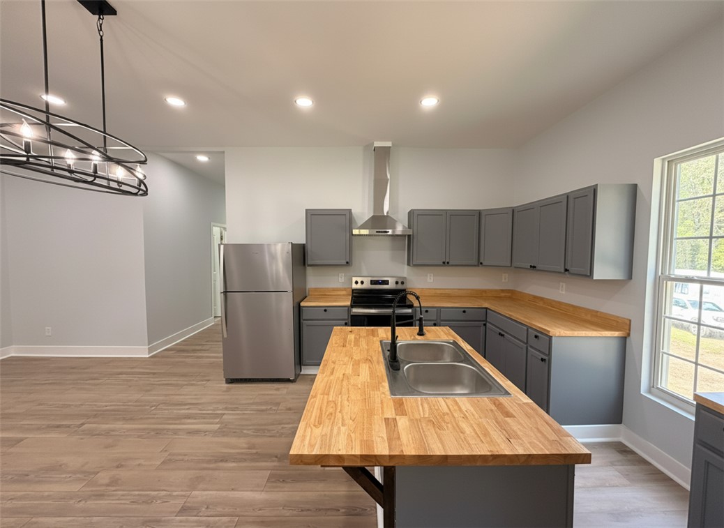 115 Hunter Street Anderson, SC 29625 - Photo 11 of 21 This bright kitchen features modern cabinetry, a kitchen island, and contemporary appliances.