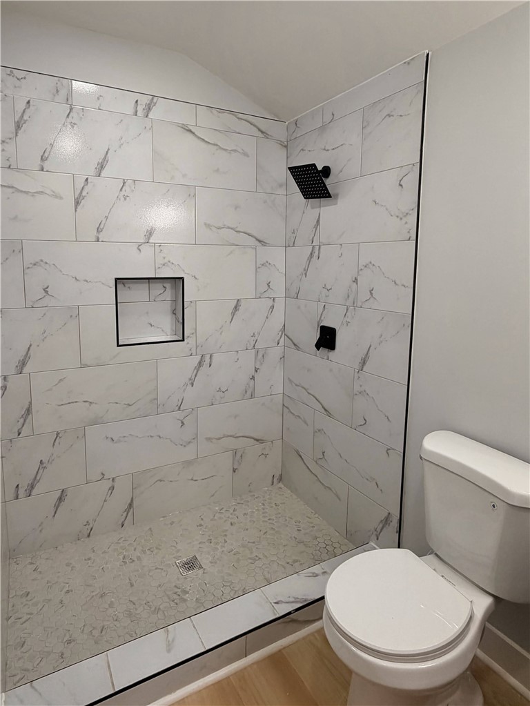115 Hunter Street Anderson, SC 29625 - Photo 16 of 21 This modern bathroom features a tiled shower and light-toned flooring.