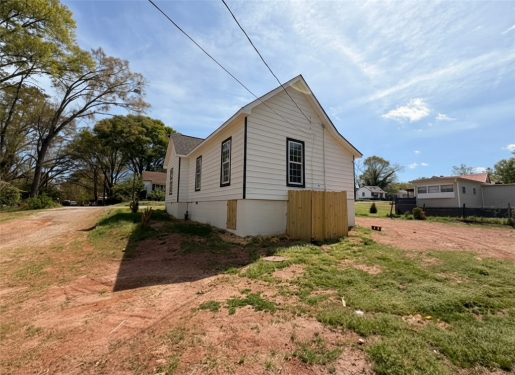115 Hunter Street Anderson, SC 29625 - Photo 3 of 21 This charming home features classic white siding and contrasting trim, offering inviting curb appeal.