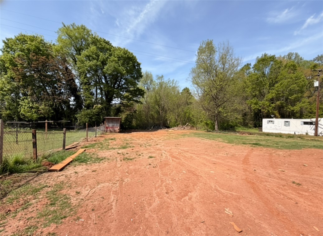 115 Hunter Street Anderson, SC 29625 - Photo 5 of 21 This spacious lot offers ample potential for development, surrounded by lush trees and natural greenery.