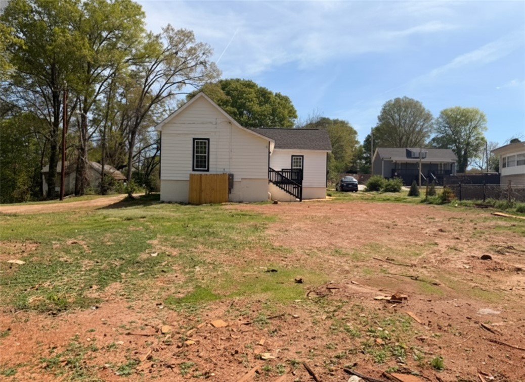 115 Hunter Street Anderson, SC 29625 - Photo 7 of 21 This charming home offers a simple facade with convenient exterior stairs.