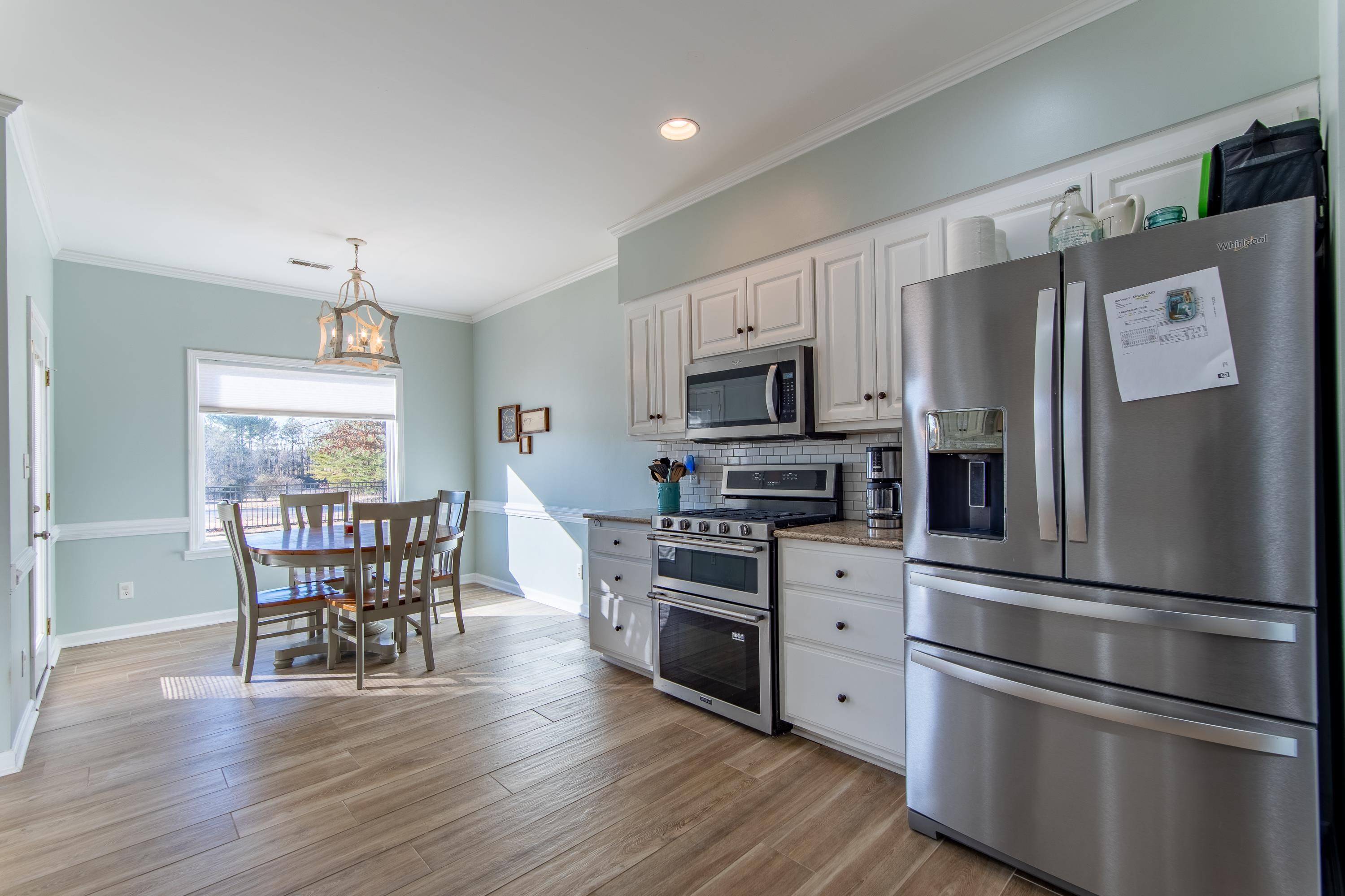 4 Rabbit Cove Corinth, MS 38834 - Photo 8 of 28 a kitchen with stainless steel appliances a dining table chairs refrigerator and microwave